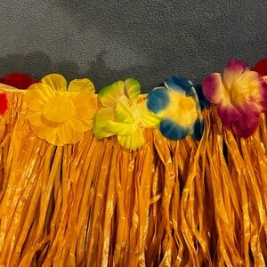 Six NEW hula skirts with an elastic waistband and adorned with colorful flowers.